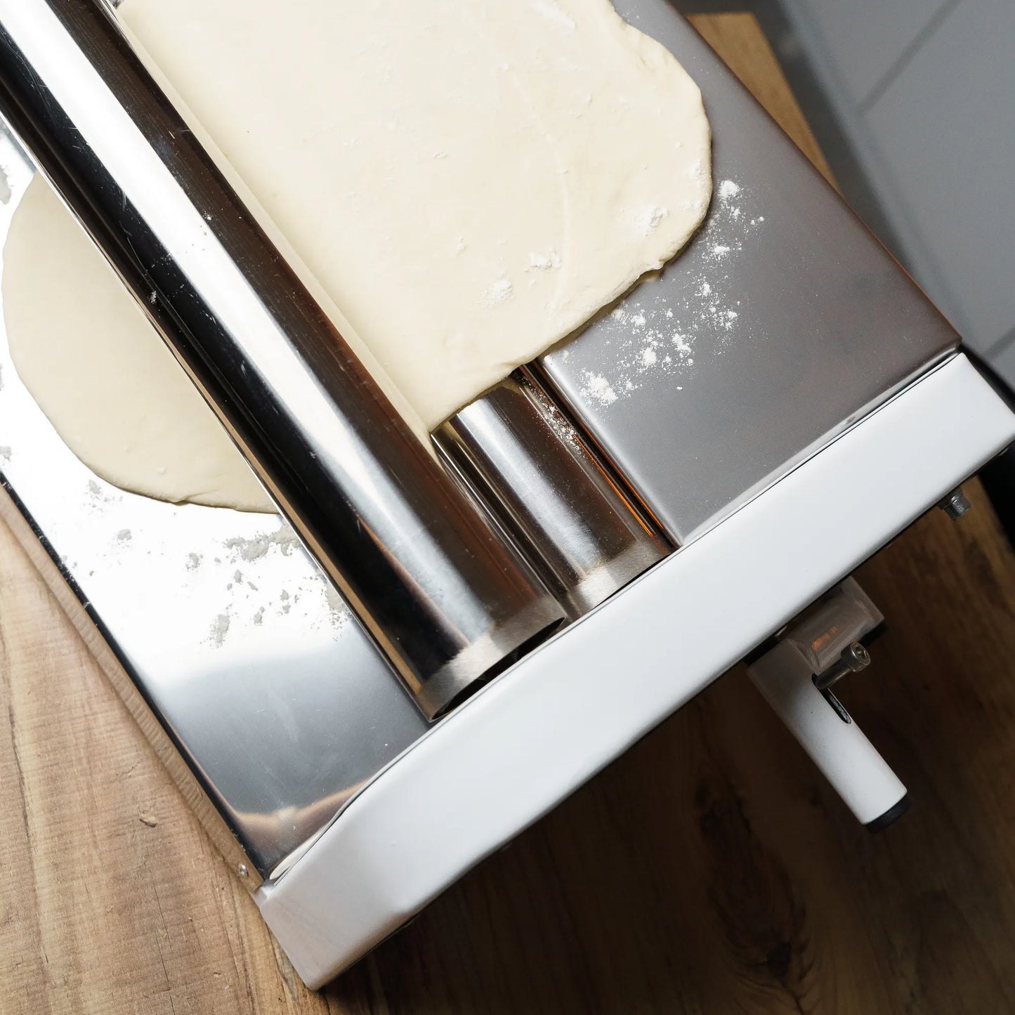 Manual dough roller flattening pizza dough